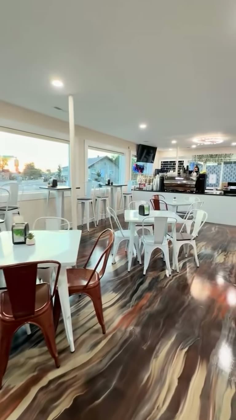 Heavenli dining room with white tables and marble-pattern floors